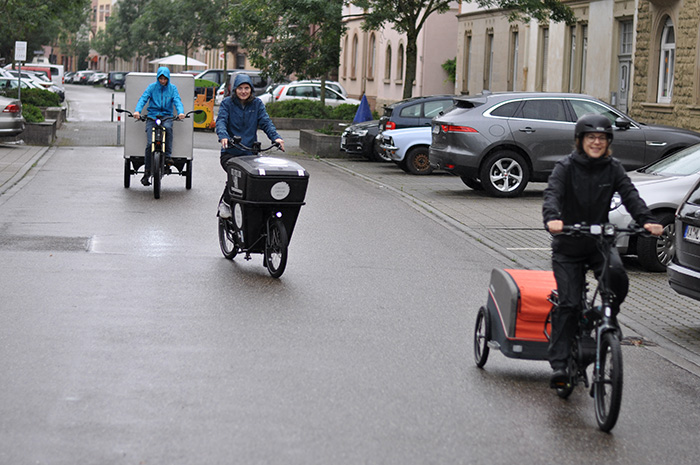 People ride on cargo bikes